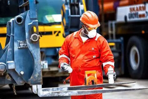 ILES field technician in certified PPE marking equipment during an inspection